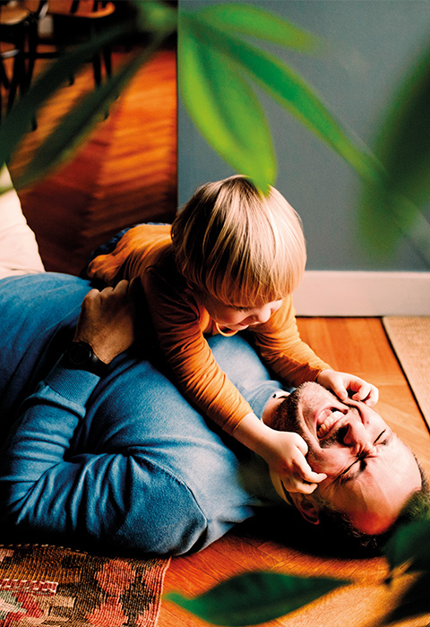 Papa jouant avec son enfant pour illustrer la page de l'épargne-pension de DVV